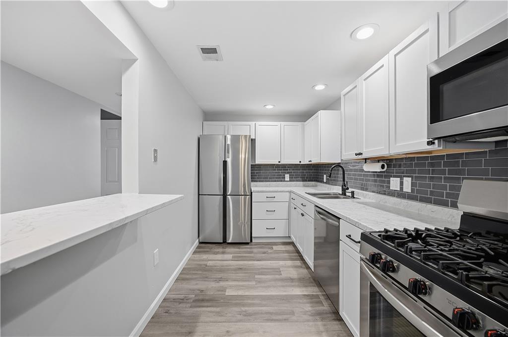 2212 Kenzie Road Pittsburgh, PA 15205 - Photo 11 of 36 a large kitchen with stainless steel appliances granite countertop a stove and a sink
