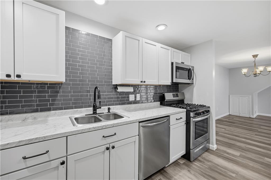 2212 Kenzie Road Pittsburgh, PA 15205 - Photo 13 of 36 a kitchen with stainless steel appliances granite countertop a sink stove and cabinets