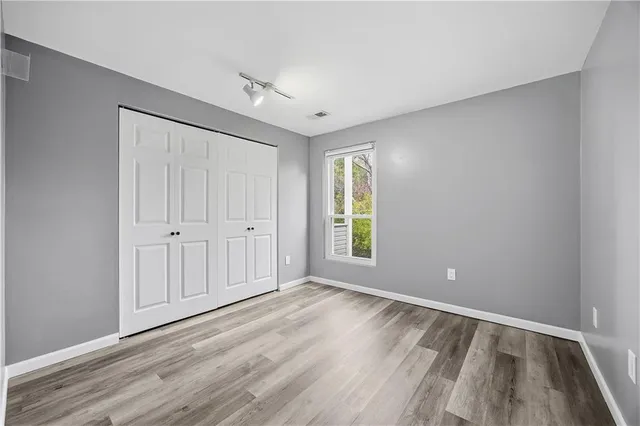 wooden floor in an empty room with a window