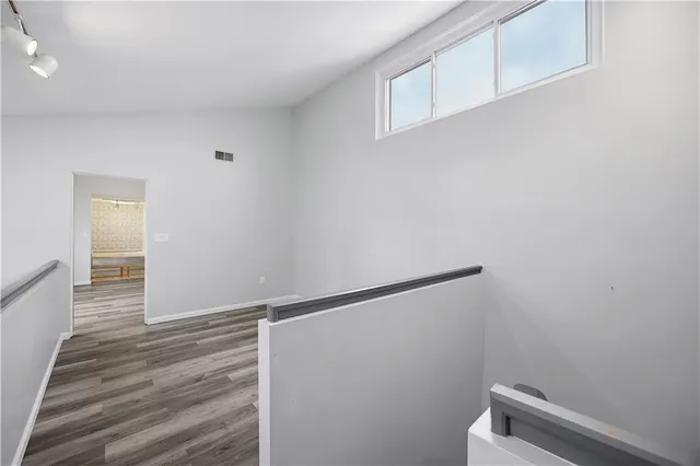 a view of hallway with wooden floor