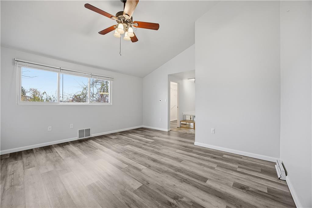2212 Kenzie Road Pittsburgh, PA 15205 - Photo 26 of 36 an empty room with wooden floor chandelier fan and windows