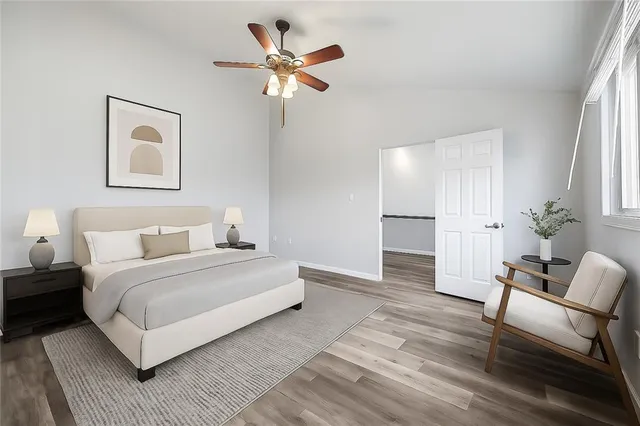 a spacious bedroom with a bed and a chair