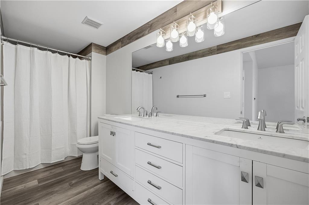 2212 Kenzie Road Pittsburgh, PA 15205 - Photo 30 of 36 a bathroom with a granite countertop sink a toilet and a mirror