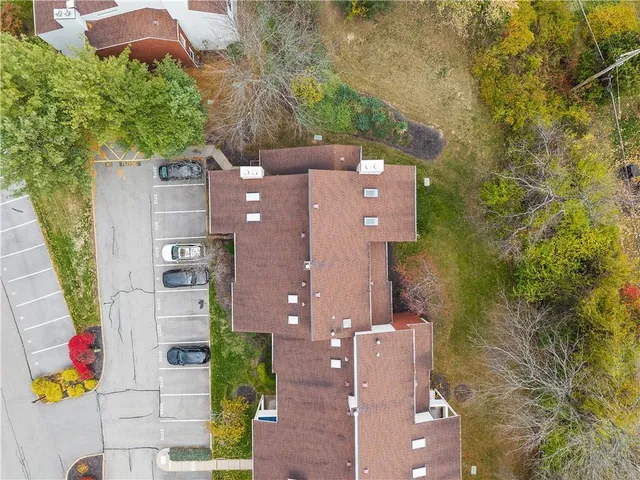 an aerial view of residential houses with outdoor space and street view