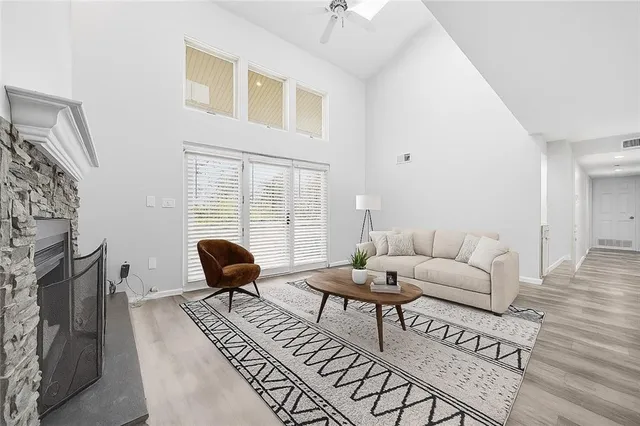a living room with furniture a fireplace and wooden floor