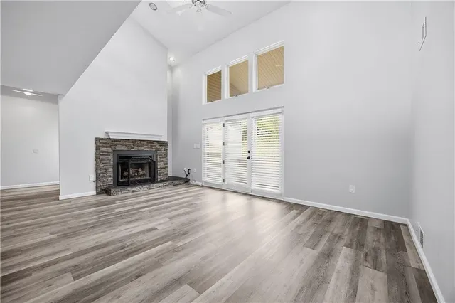 a view of empty room with wooden floor and fireplace