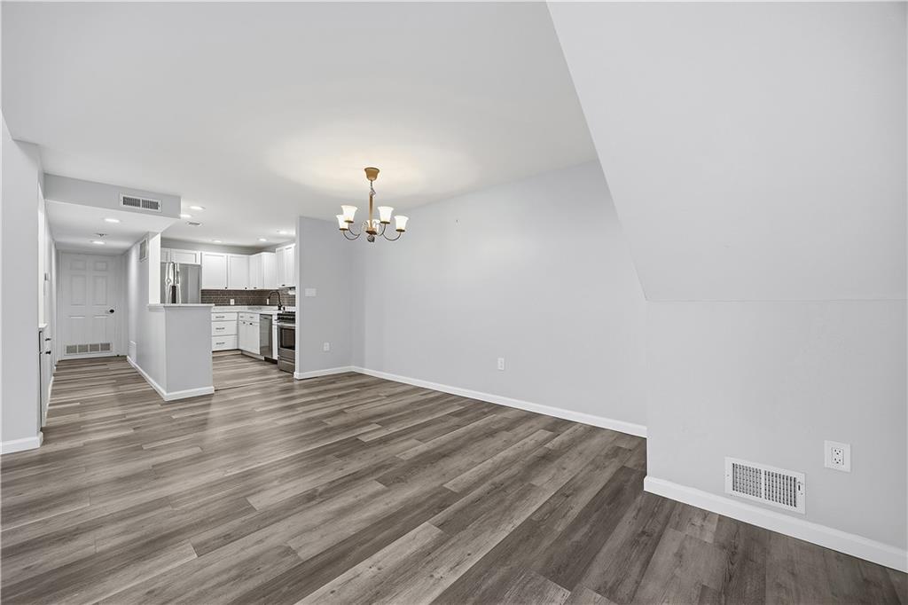 2212 Kenzie Road Pittsburgh, PA 15205 - Photo 8 of 36 a view of a room with wooden floor and a kitchen