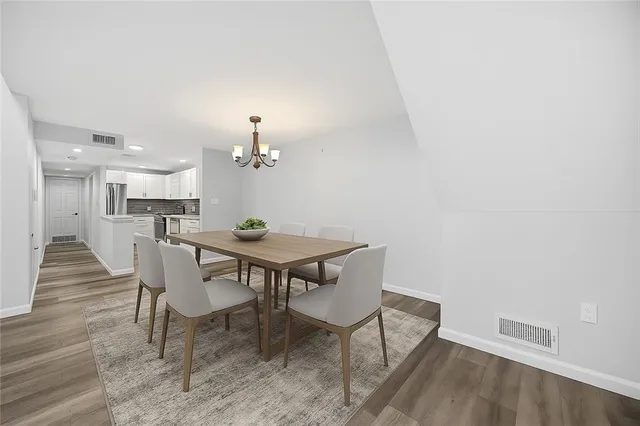a view of a dining room with furniture and wooden floor