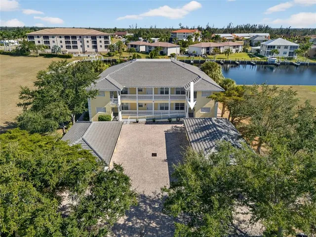an aerial view of a house with a garden and lake view