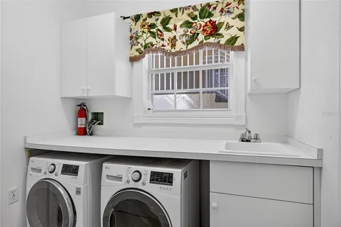 a view of a swimming pool with a patio and a fountain
