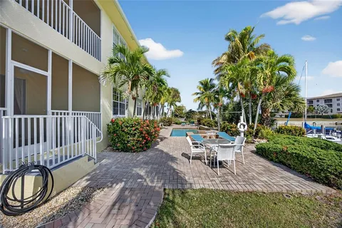 a view of swimming pool with outdoor seating and plants