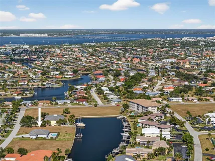 a kitchen with stainless steel appliances granite countertop a sink a stove a refrigerator cabinets and a sink