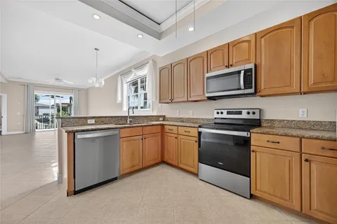 a view of a kitchen with a sink a refrigerator and a window