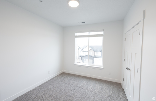 4653 South Alder Drive, Unit H302 Mapleton, UT 84664 - Photo 11 of 15 Unfurnished bedroom featuring carpet and baseboards