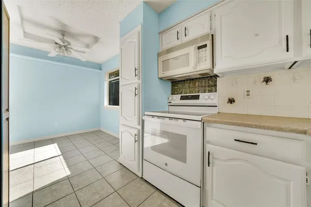 a kitchen with cabinets and stainless steel appliances