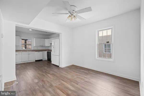 a view of a kitchen with a sink cabinets and wooden floor