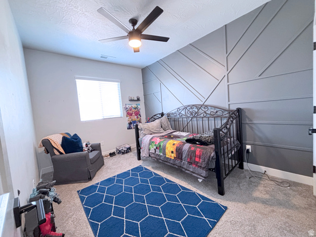 429 East Treasure Road Washington, UT 84780 - Photo 20 of 36 Carpeted bedroom with ceiling fan and a textured ceiling
