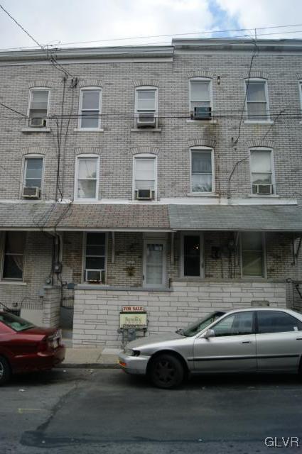 a couple of cars parked in front of a building