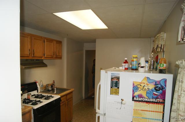 522 North Jordan Street Allentown, PA 18102 - Photo 6 of 11 a kitchen with a stove and cabinets