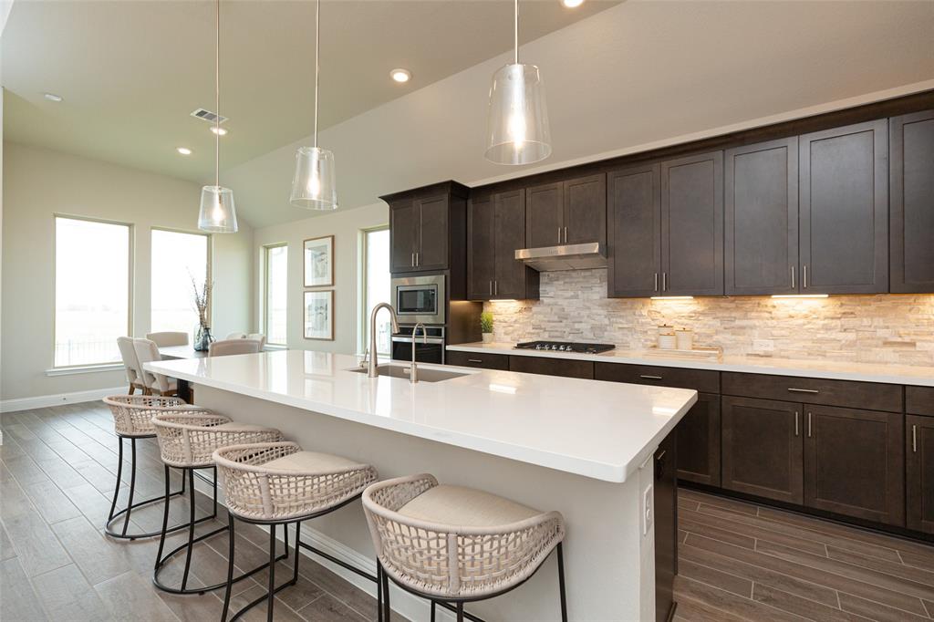 a large kitchen with kitchen island a large island in the center