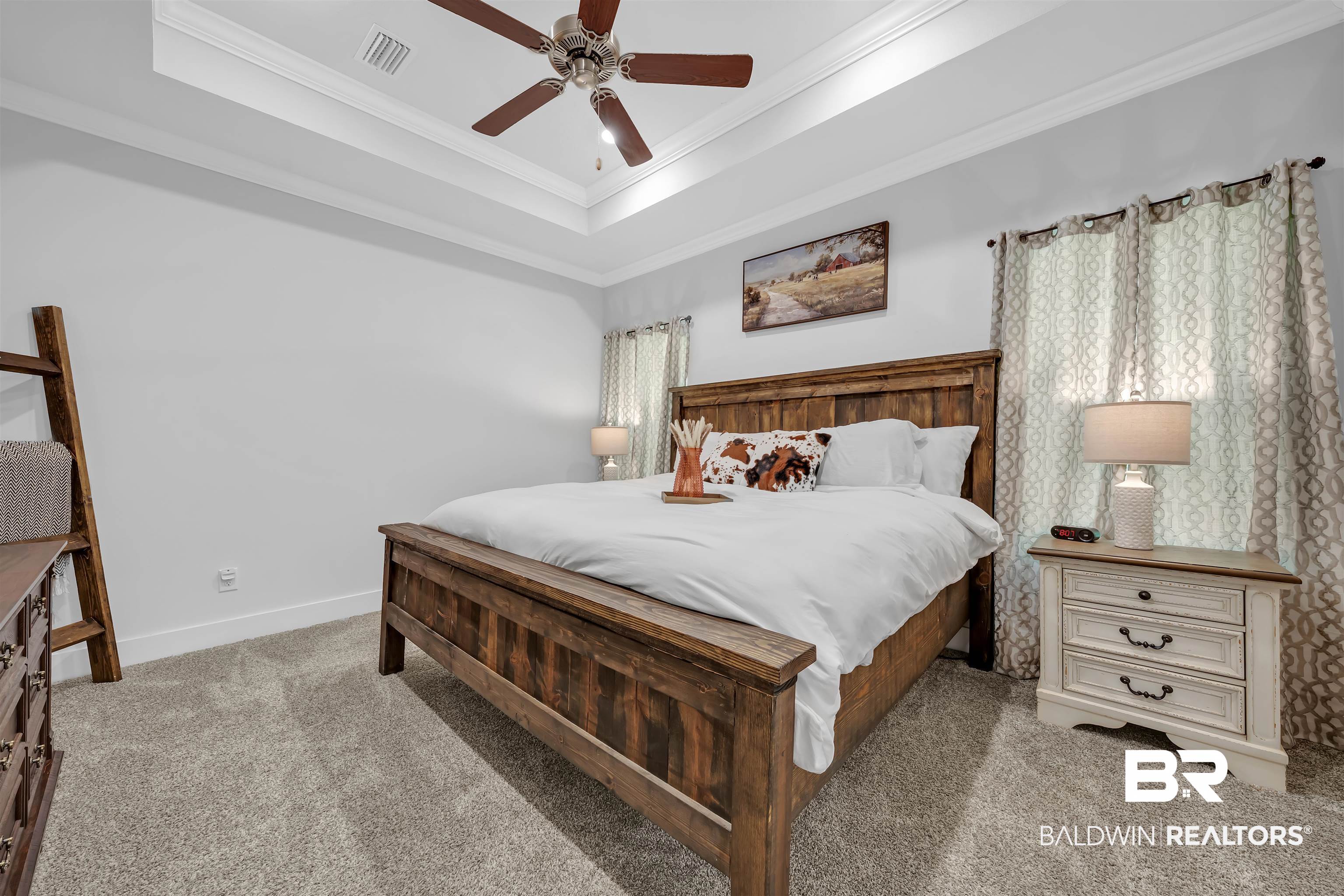 16504 Prado Loop Loxley, AL 36551 - Photo 27 of 45 Carpeted bedroom with a raised ceiling, ceiling fan, and ornamental molding