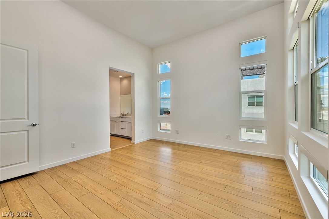 3327 Esker Rdg Avenue Henderson, NV 89044 - Photo 10 of 24 Bright hardwood floors, polar auto shades and abundant natural light define this inviting space.