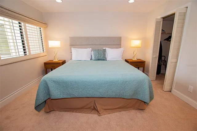 a bedroom with a bed and window