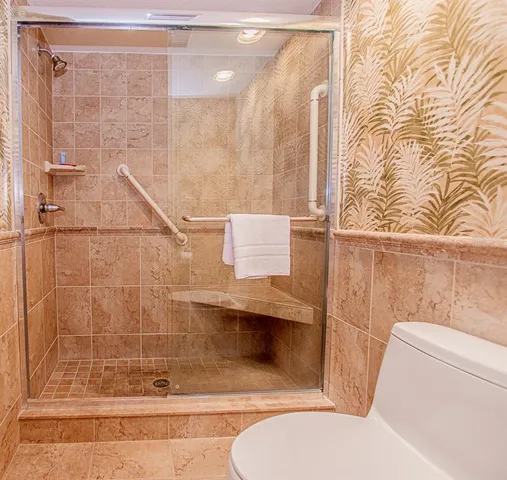 a bathroom with a toilet and shower
