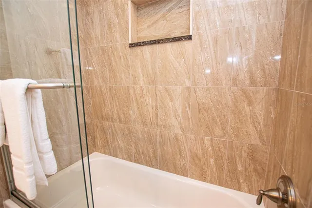 a bathroom with a shower and a tub
