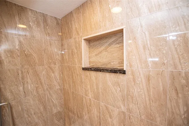a bathroom with a shower curtain and a window