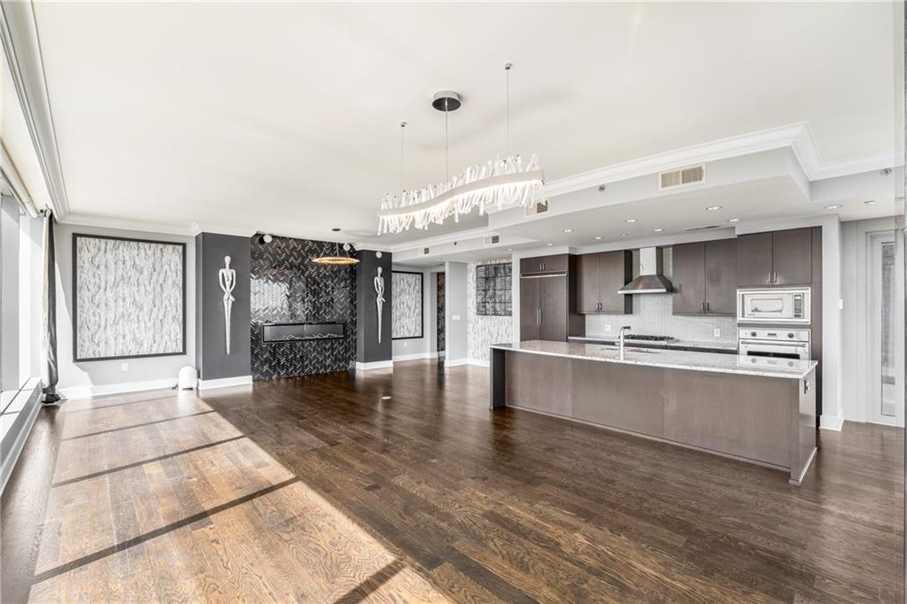 3630 Peachtree Road Northeast, Unit 2404 Atlanta, GA 30326 - Photo 13 of 48 a large white kitchen with a large window and stainless steel appliances