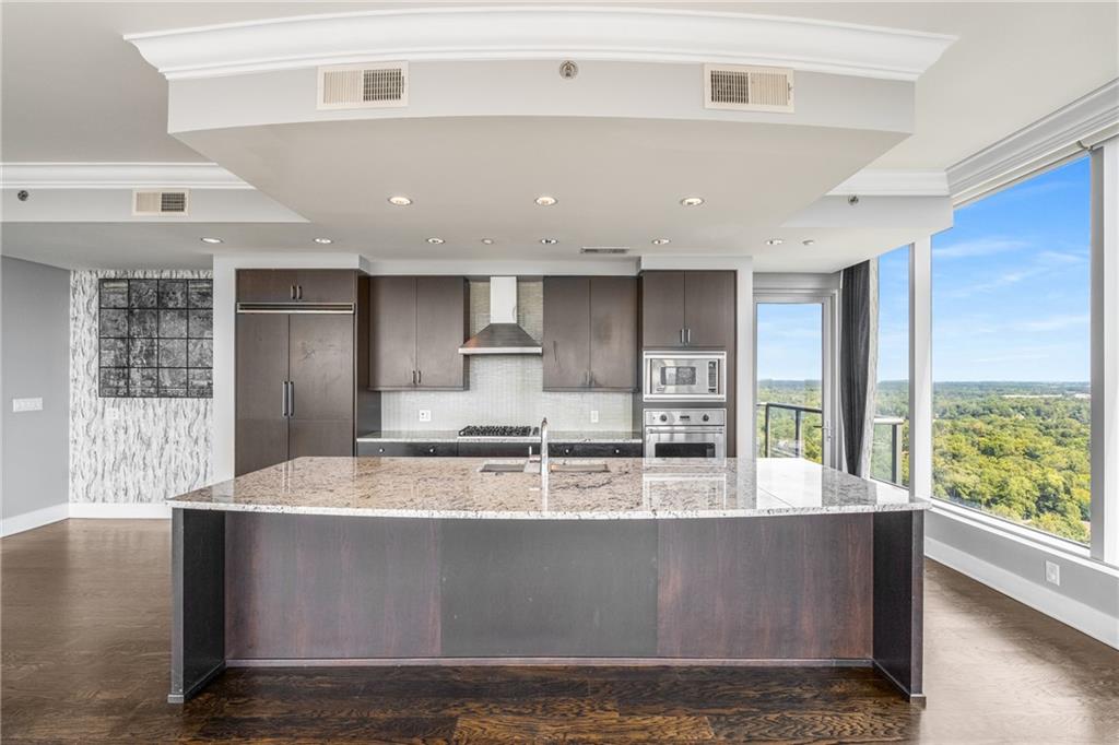 3630 Peachtree Road Northeast, Unit 2404 Atlanta, GA 30326 - Photo 14 of 48 a large kitchen with stainless steel appliances a large counter top