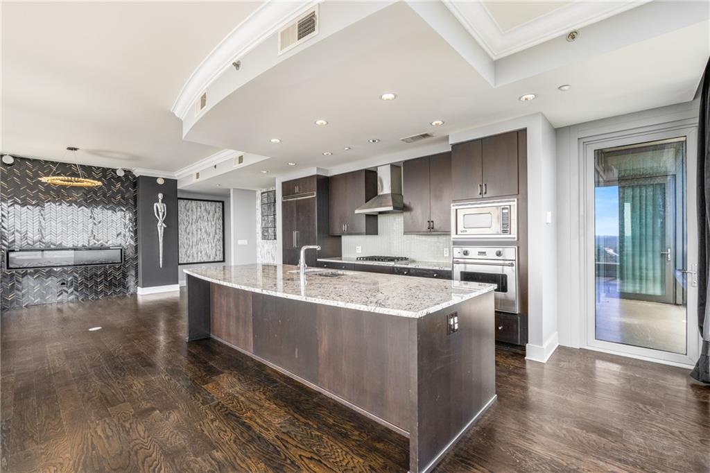 3630 Peachtree Road Northeast, Unit 2404 Atlanta, GA 30326 - Photo 15 of 48 a large kitchen with stainless steel appliances and a large window