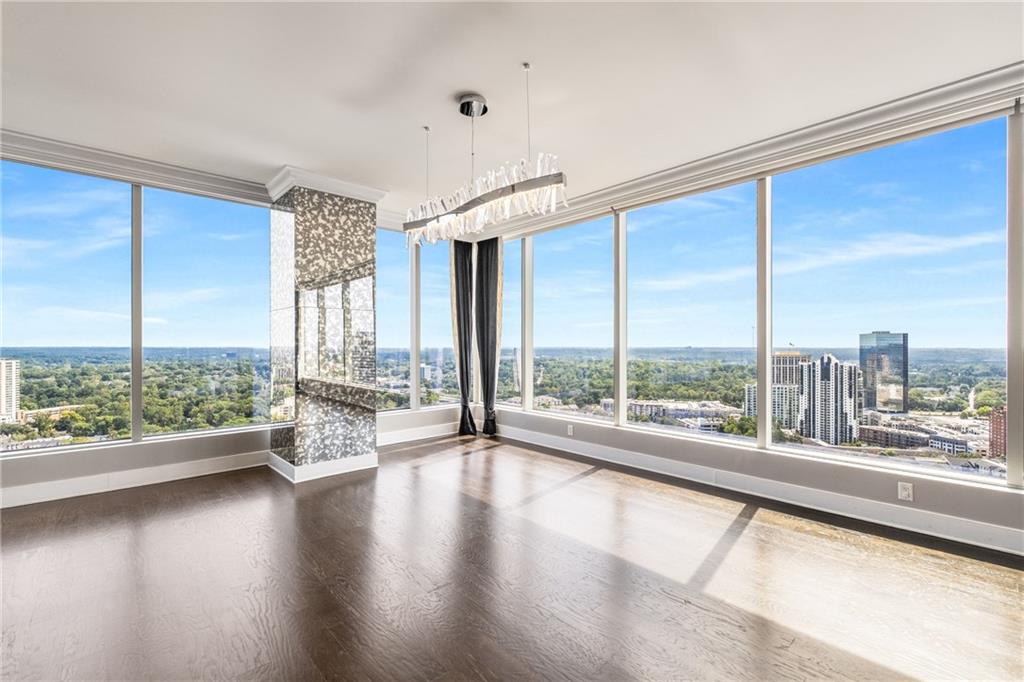 3630 Peachtree Road Northeast, Unit 2404 Atlanta, GA 30326 - Photo 16 of 48 a view of an empty room with wooden floor and a window