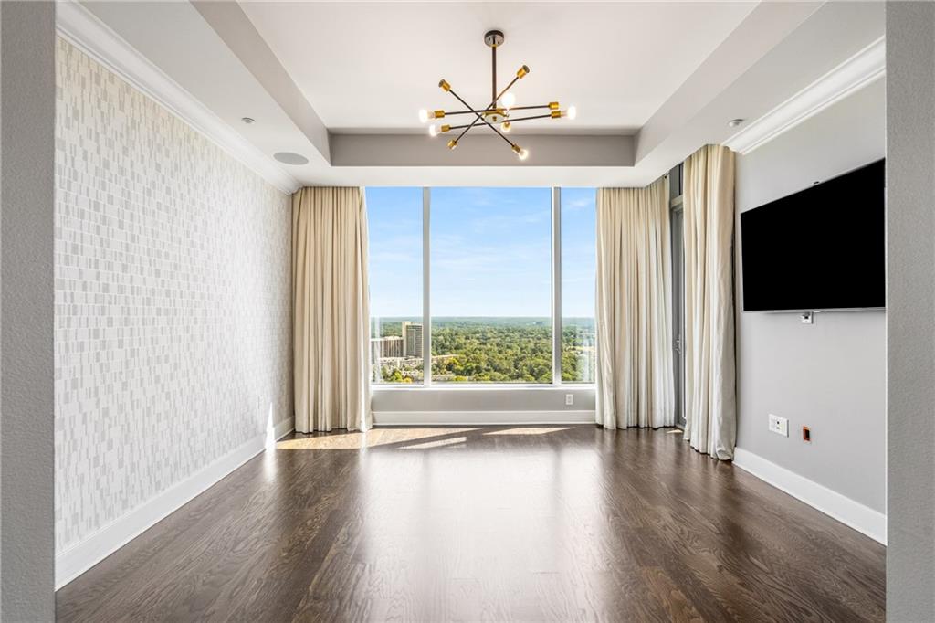 3630 Peachtree Road Northeast, Unit 2404 Atlanta, GA 30326 - Photo 17 of 48 a view of a livingroom with wooden floor and a flat screen tv