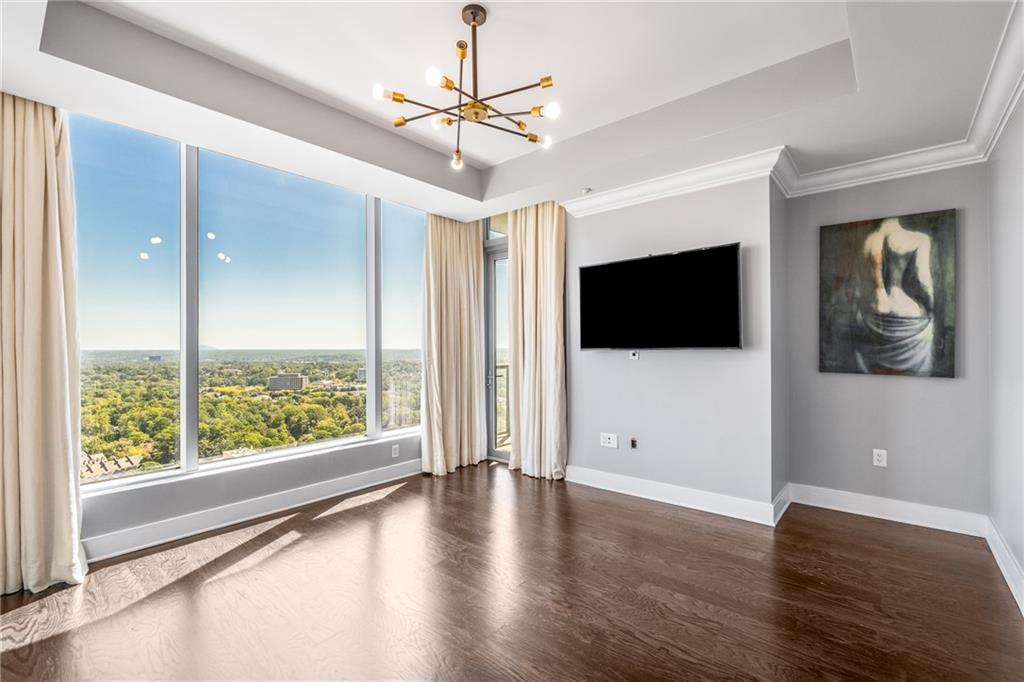 3630 Peachtree Road Northeast, Unit 2404 Atlanta, GA 30326 - Photo 18 of 48 a view of a livingroom with wooden floor windows and a chandelier