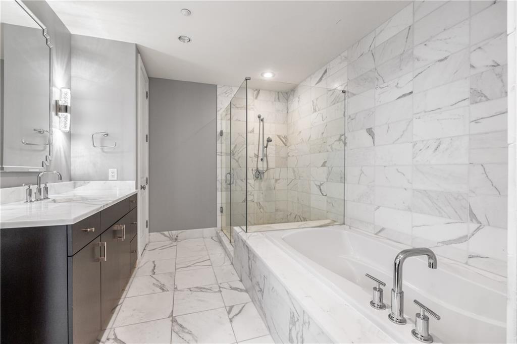 3630 Peachtree Road Northeast, Unit 2404 Atlanta, GA 30326 - Photo 20 of 48 a spacious bathroom with a granite countertop sink a toilet a mirror and shower
