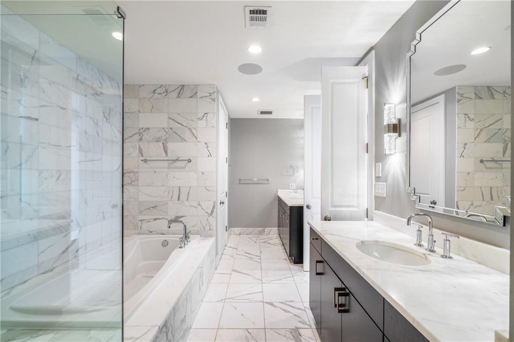 3630 Peachtree Road Northeast, Unit 2404 Atlanta, GA 30326 - Photo 21 of 48 a bathroom with a granite countertop sink mirror and shower