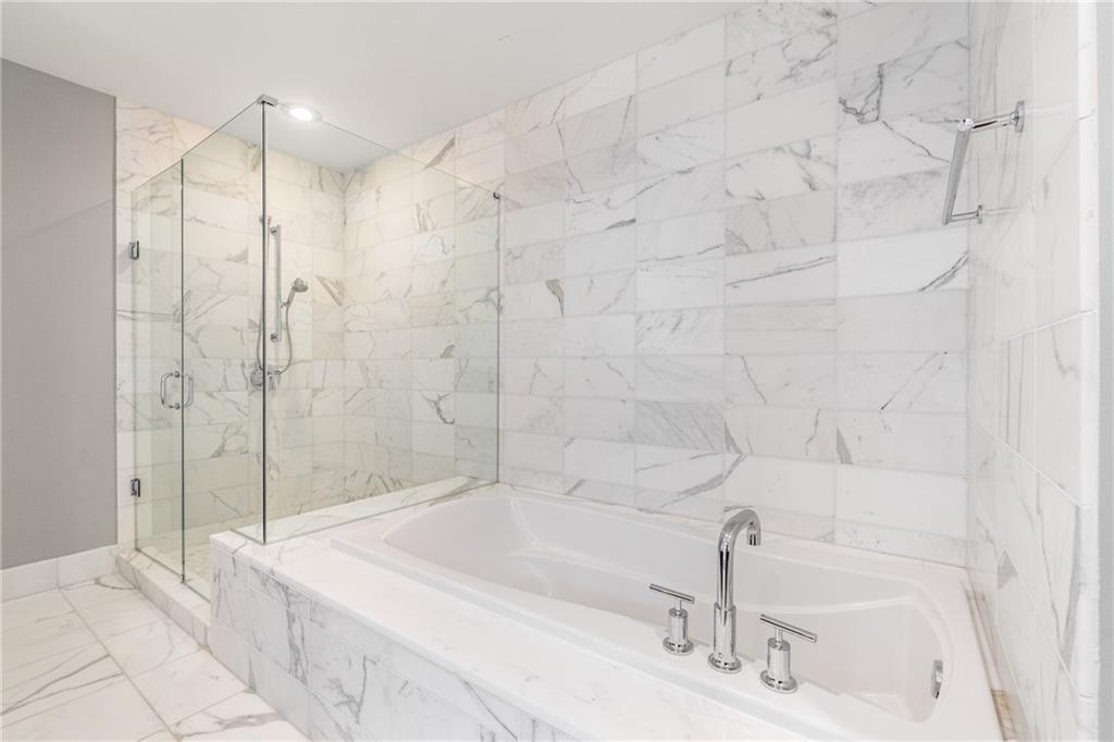 3630 Peachtree Road Northeast, Unit 2404 Atlanta, GA 30326 - Photo 22 of 48 a bathroom with a bathtub and shower