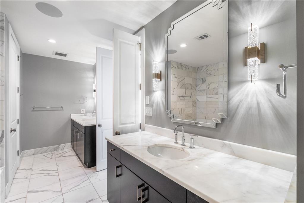 3630 Peachtree Road Northeast, Unit 2404 Atlanta, GA 30326 - Photo 23 of 48 a bathroom with a sink and a mirror