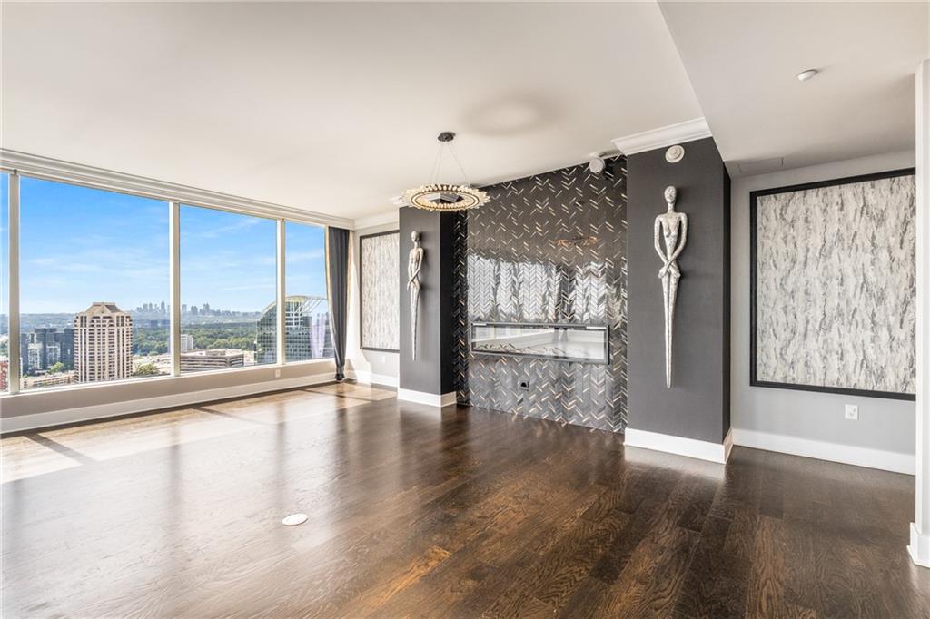 3630 Peachtree Road Northeast, Unit 2404 Atlanta, GA 30326 - Photo 27 of 48 a view of an empty room with wooden floor and a window