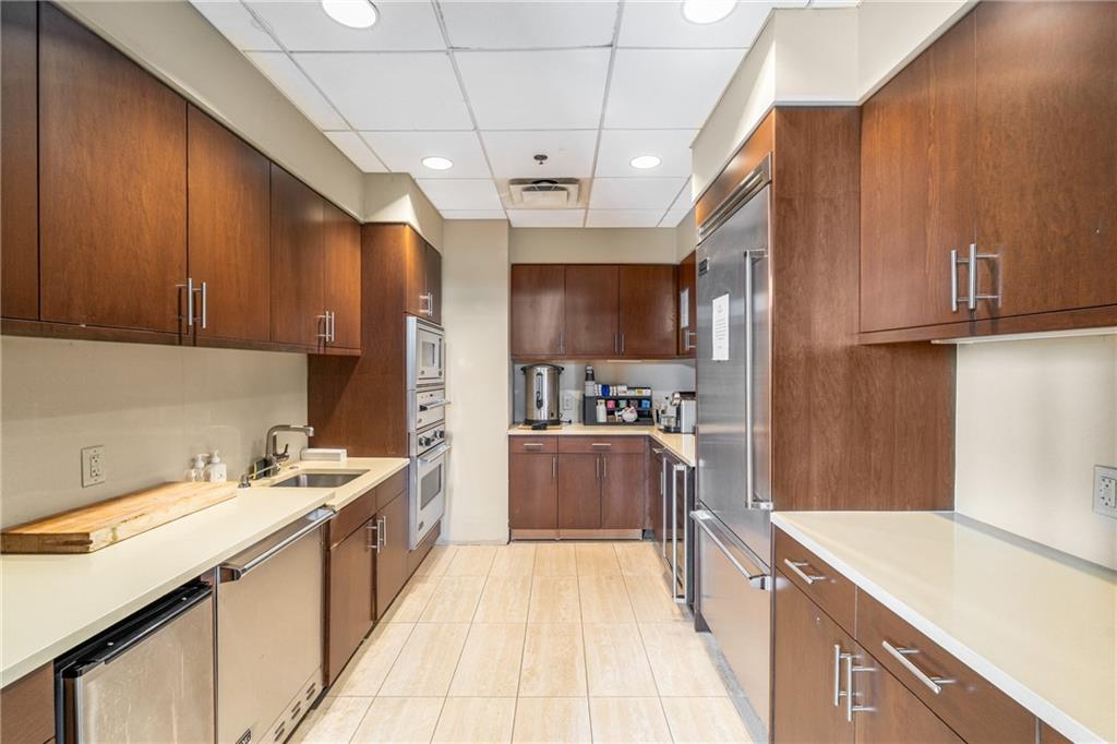 3630 Peachtree Road Northeast, Unit 2404 Atlanta, GA 30326 - Photo 39 of 48 a kitchen with a sink stove and refrigerator