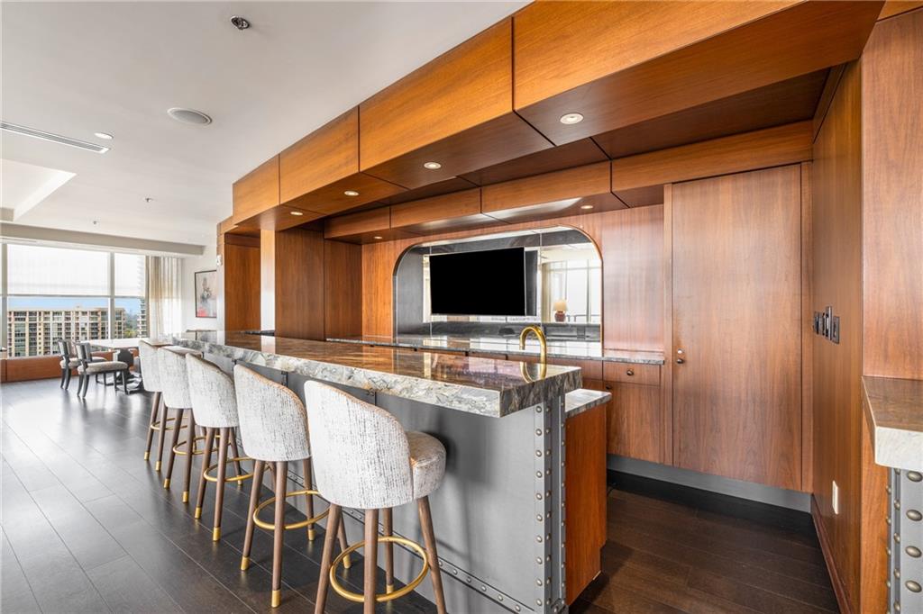 3630 Peachtree Road Northeast, Unit 2404 Atlanta, GA 30326 - Photo 47 of 48 a dining hall with stainless steel appliances granite countertop a sink and a microwave