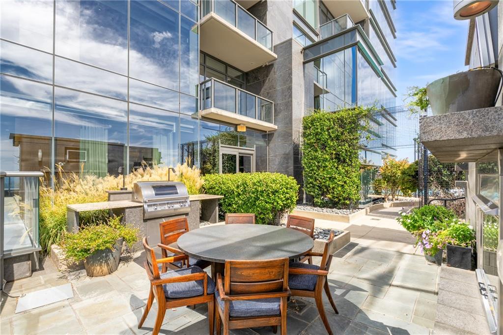 3630 Peachtree Road Northeast, Unit 2404 Atlanta, GA 30326 - Photo 48 of 48 a view of a patio with table and chairs and potted plants