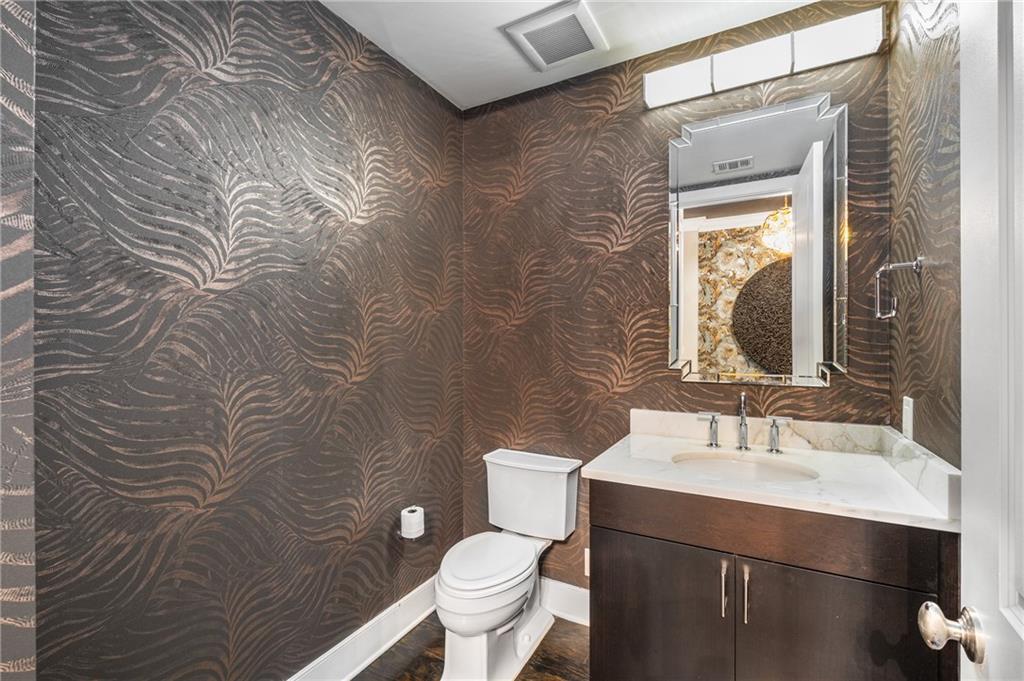 3630 Peachtree Road Northeast, Unit 2404 Atlanta, GA 30326 - Photo 5 of 48 a bathroom with a toilet sink and mirror