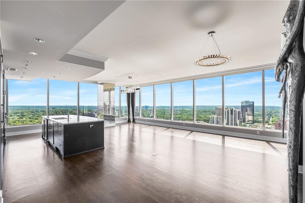 3630 Peachtree Road Northeast, Unit 2404 Atlanta, GA 30326 - Photo 6 of 48 a view of an empty room with wooden floor and a large window