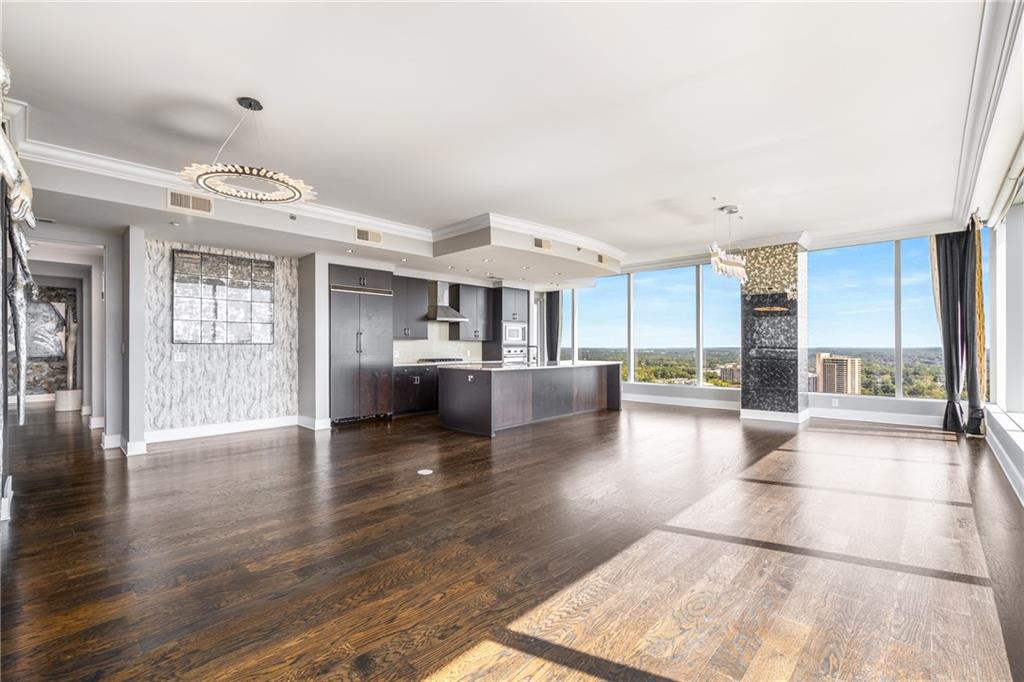 3630 Peachtree Road Northeast, Unit 2404 Atlanta, GA 30326 - Photo 7 of 48 a view of a living room kitchen with furniture and wooden floor