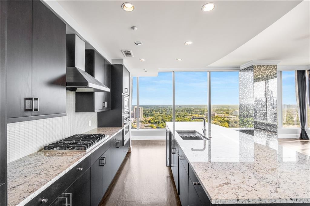 3630 Peachtree Road Northeast, Unit 2404 Atlanta, GA 30326 - Photo 9 of 48 a view of a kitchen with kitchen island granite countertop a large window