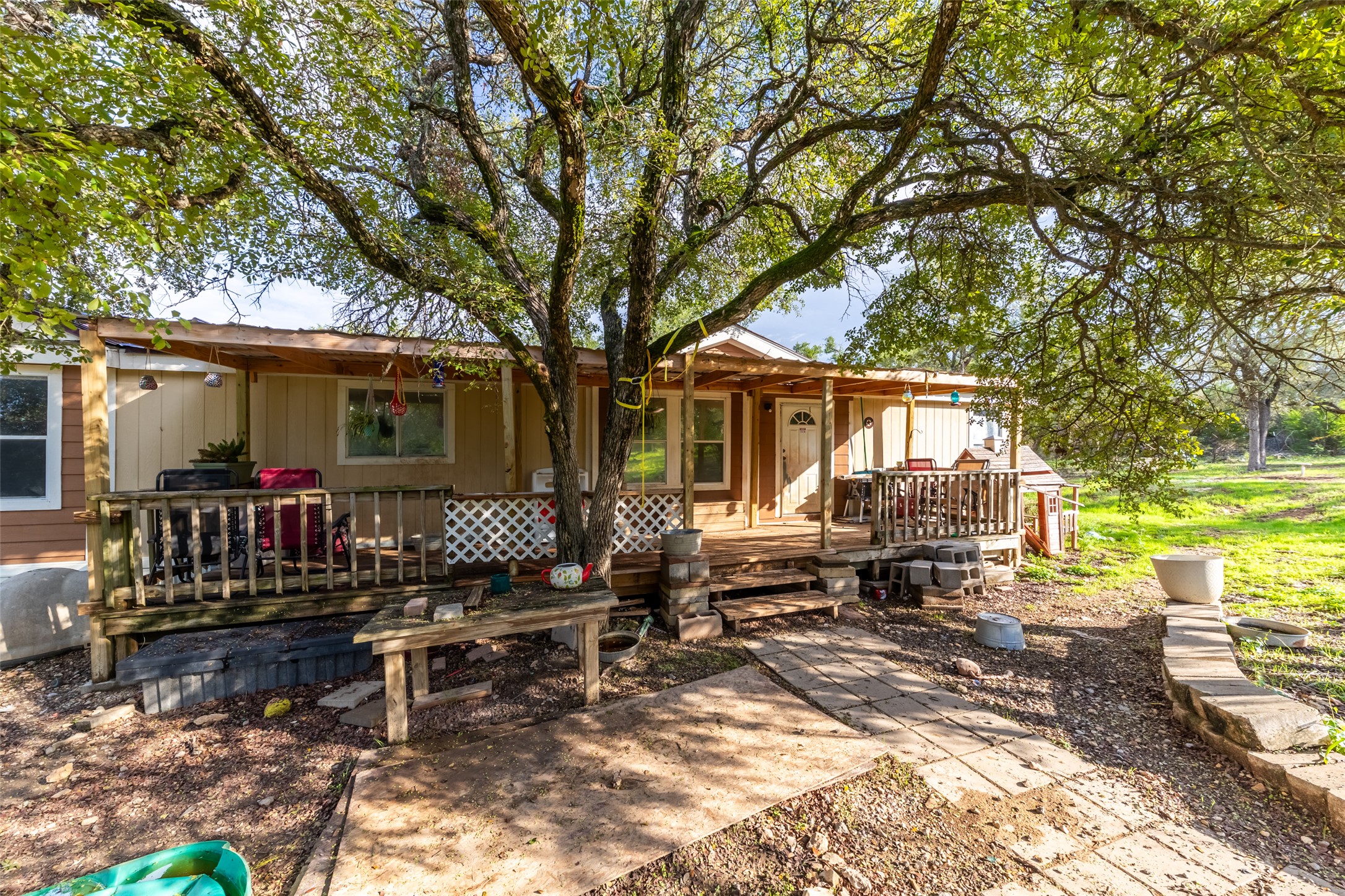 212 Fox Road San Marcos, TX 78666 - Photo 16 of 18 a view of house with patio outdoor seating and covered with trees