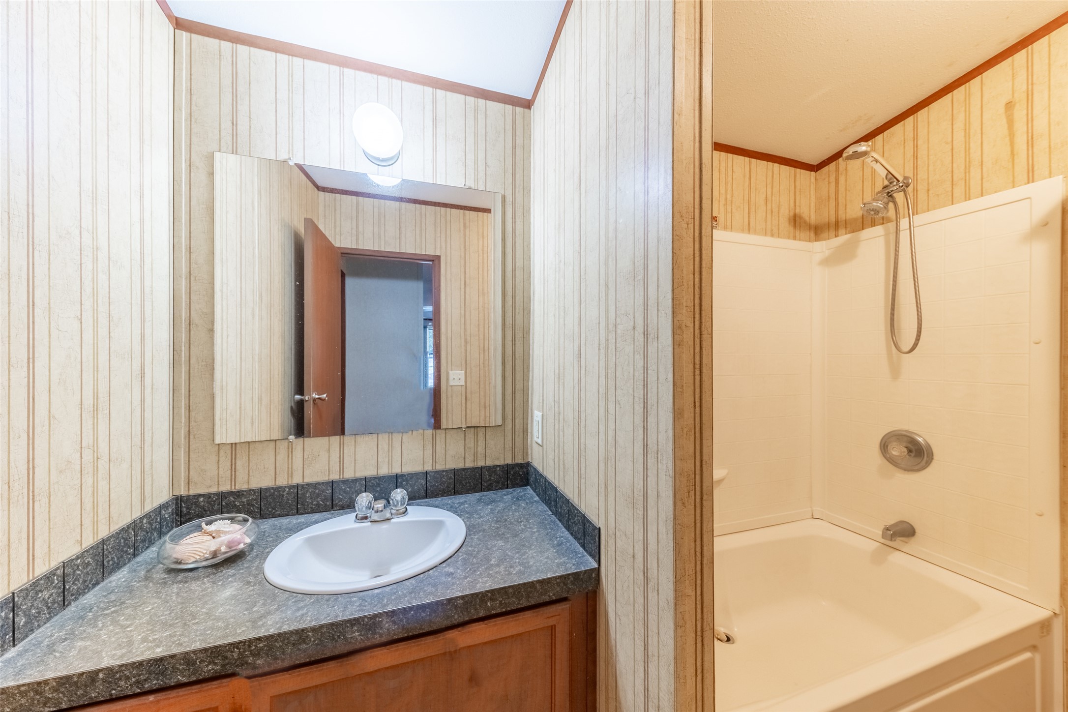 212 Fox Road San Marcos, TX 78666 - Photo 5 of 18 a bathroom with a granite countertop sink and a mirror